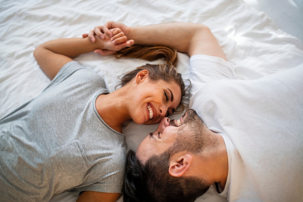 Pretty,Female,Looking,At,Her,Boyfriend,In,Bed,Stock,Photo.